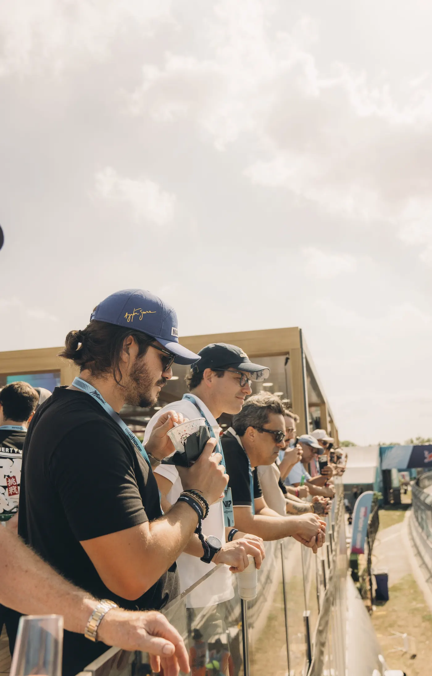 Guests along the balcony rail watching the Miami circuit