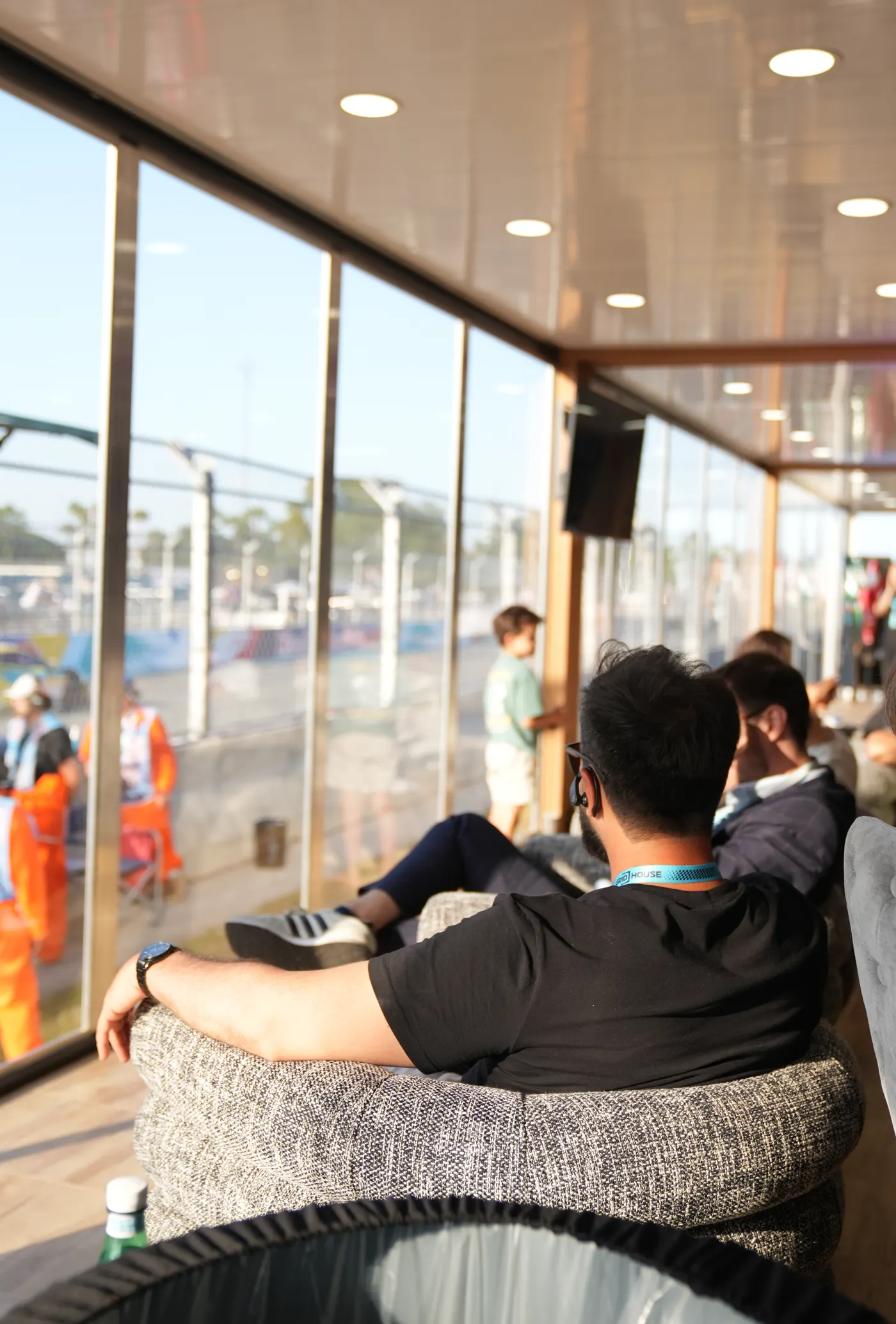 A guest seated inside the suite looking out over the track