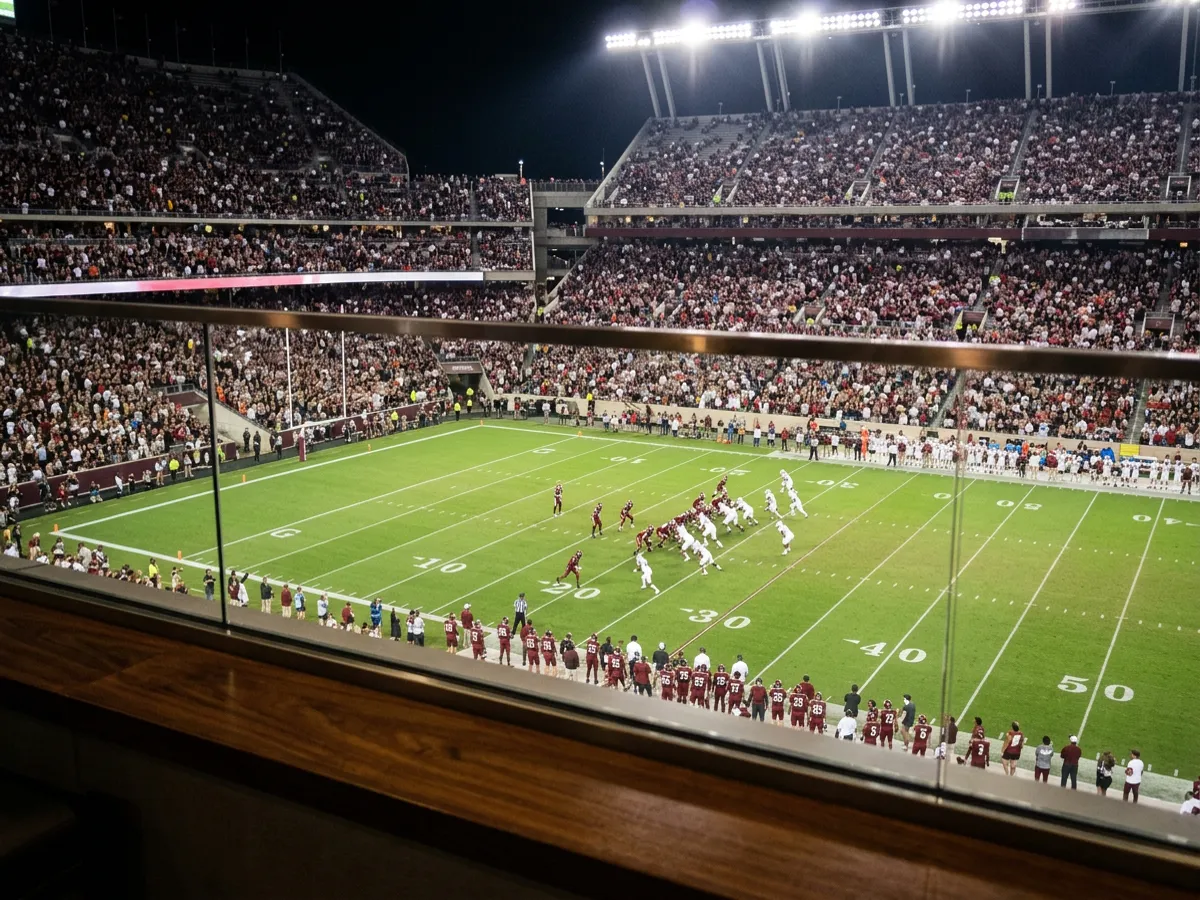 Conceptual image: an American football play seen from a stadium suite, generic unbranded uniforms