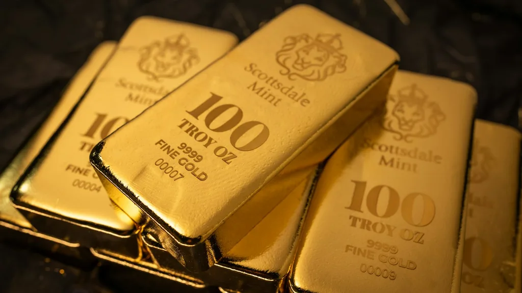Stacked fine-gold bullion bars on a dark surface