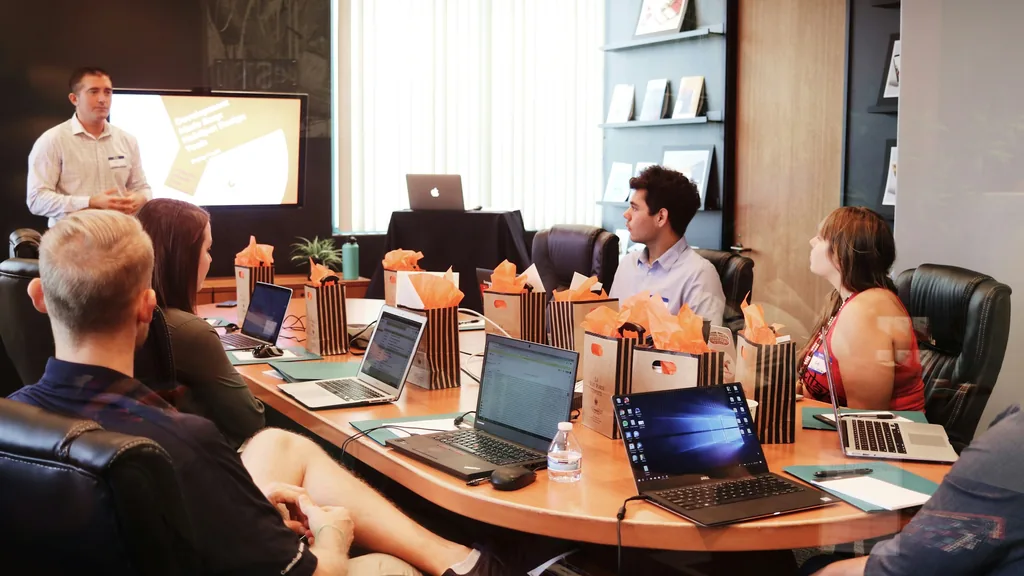 A founder presenting to a small group around a boardroom table